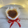 Burnt Basque cheesecake wrapped with parchment paper and red ribbon gift style