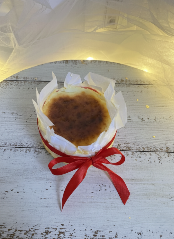 Burnt Basque cheesecake wrapped with parchment paper and red ribbon gift style