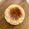 Burnt Basque cheesecake top view on wooden board with caramelized surface