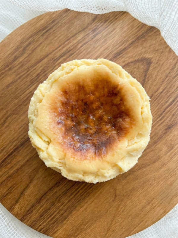 Burnt Basque cheesecake top view on wooden board with caramelized surface