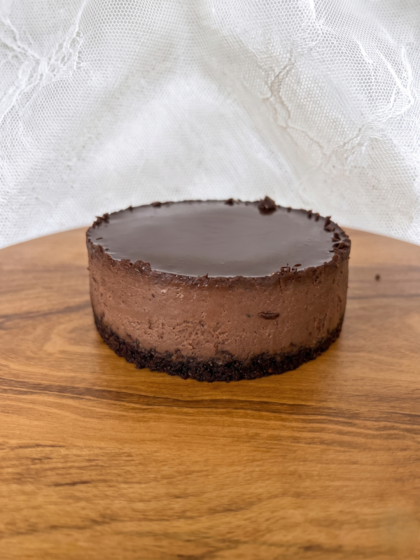 Chocolate cheesecake with smooth ganache top and dense creamy texture