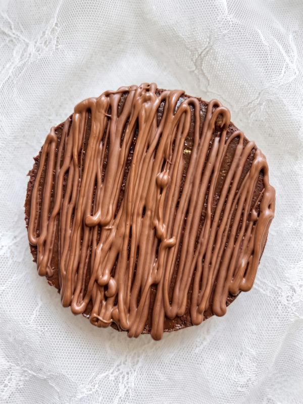 Top view of chocolate cheesecake with chocolate drizzle pattern