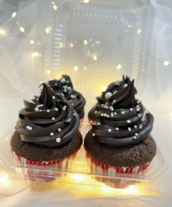 Chocolate cupcakes with rich chocolate frosting and sprinkles in a box