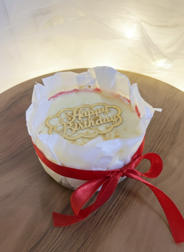 Plain New York cheesecake on wooden board with smooth creamy top